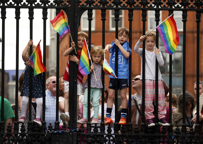 Children wave rainbow flags as they stand with their same-sex marriage supporting parents at Dublin Castle in Dublin, Ireland May 23, 2015. (Reuters / Cathal McNaughton)