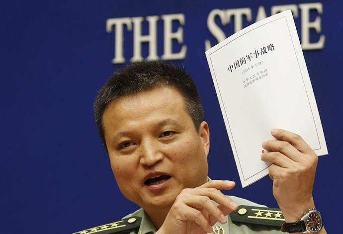 Spokesperson of Chinese Ministry of National Defense Senior Colonel Yang Yujun holds a copy of the annual white paper on China's military strategy during a news conference in Beijing, China, May 26, 2015 (Reuters / Kim Kyung-Hoon)