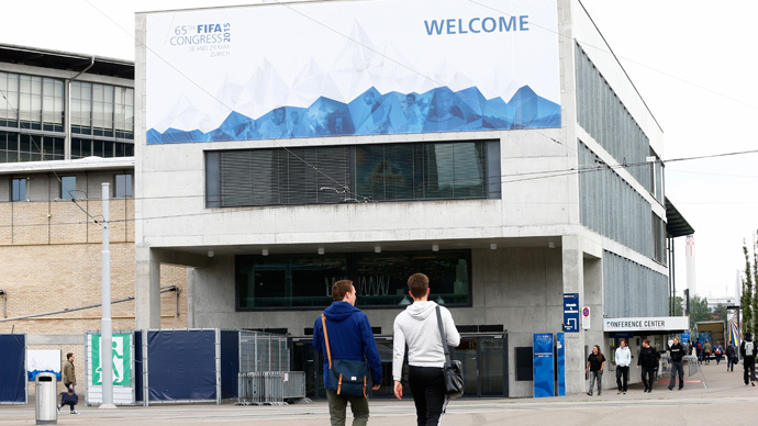 People walk in front of the Hallenstadion, where the upcoming 65th FIFA Congress will take place in Zurich, Switzerland, May 27, 2015. (Reuters / Arnd Wiegmann)