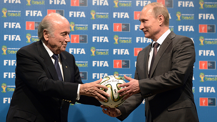 Russia's President Vladimir Putin (R) and FIFA President Sepp Blatter take part in the official hand over ceremony for the 2018 World Cup scheduled to take place in Russia, in Rio de Janeiro July 13, 2014 (Reuters / Alexey Nikolsky)