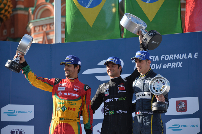 Winners of the FIA Formula E Championship in Moscow during the awarding ceremony. From left: Lucas di Grassi of the Audi Sport Abt team, second place; Nelson Piquet Jr. of the NEXTEV TCR team, first place, and Sebastien Buemi of the e.dams-Renault, third place. (RIA Novosti / Alexey Kudenko) 