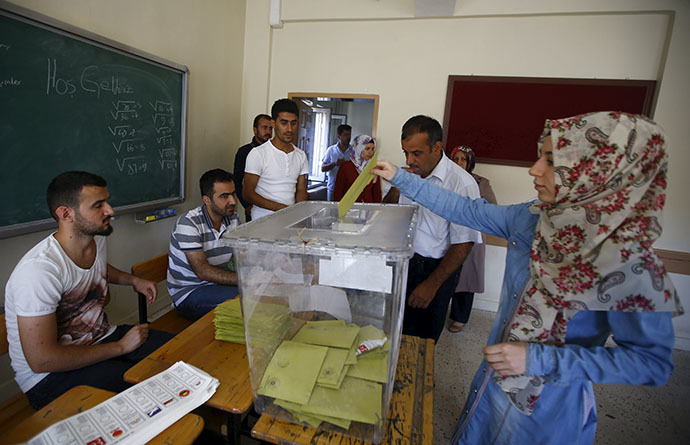 A woman casts her ballot at a polling station during the parliamentary election in Diyarbakir, Turkey, June 7, 2015. (Reuters/Osman Orsal)