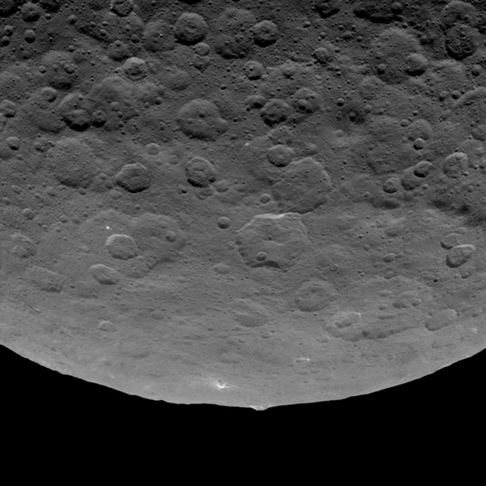 Short caption: This image, taken by NASA's Dawn spacecraft on June 14, 2015, shows an intriguing mountain on dwarf planet Ceres protruding from a relatively smooth area. (Image credit: NASA/JPL-Caltech/UCLA/MPS/DLR/IDA)