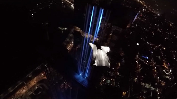 Model in glowing wingsuit lights up night skies over Panama City (VIDEO)