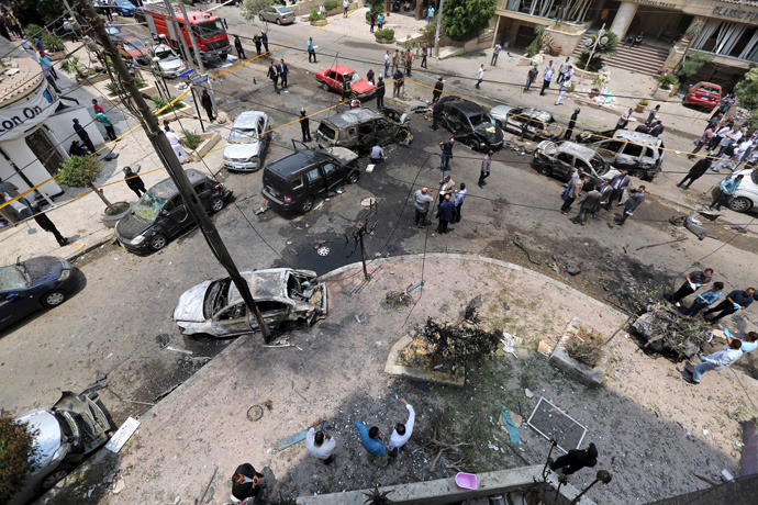 A view shows burnt cars at the site of a car bomb attacked the convoy of Egyptian public prosecutor Hisham Barakat near his house at Heliopolis district in Cairo, Egypt, June 29, 2015. (Reuters / Mohamed Abd El Ghany)