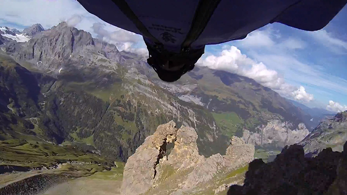 Pilot in wing suit makes 'craziest base jump ever' through tiny mountain hole (VIDEO)