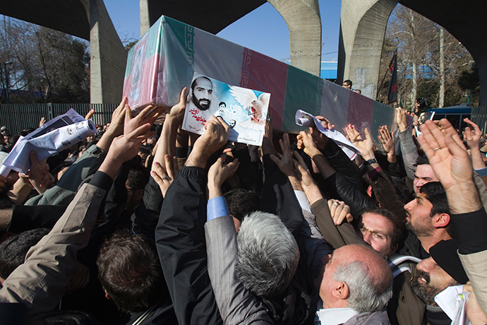 Iranian worshippers carry a picture and coffin of Iranian nuclear scientist Mostafa Ahmadi-Roshan, who was killed in a bomb blast in Tehran on January 11, during his funeral after Friday prayers in Tehran January 13, 2012 (Reuters / Morteza Nikoubazl)