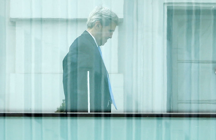 U.S. Secretary of State John Kerry walks on the terrace of Palais Coburg, the venue for nuclear talks in Vienna, Austria, July 12, 2015. (Reuters/Leonhard Foeger)