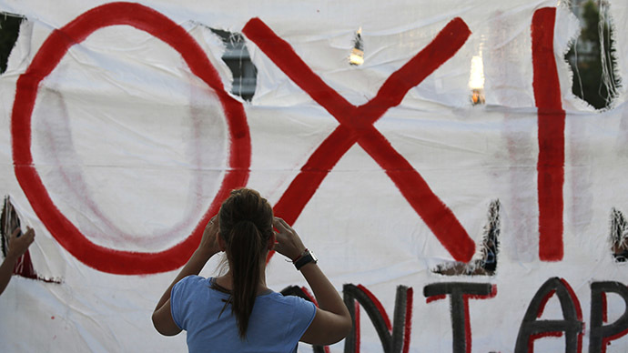 The word "No" in Greek is seen on a banner as anti-austerity protesters gather in front of the Parliament building in Athens, Greece, July 12, 2015. (Reuters / Yannis Behrakis)