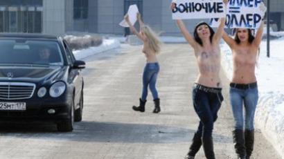 Topless attack: FEMEN dump Euro trophy in protest (VIDEO)