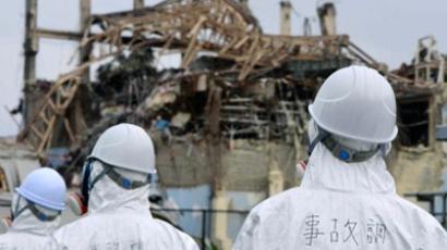 Fukushima operator says “sorry” as workers erect protective cap
