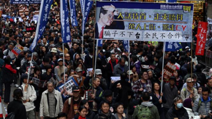 Tens of thousands march in rival protests over Hong Kong’s leader 