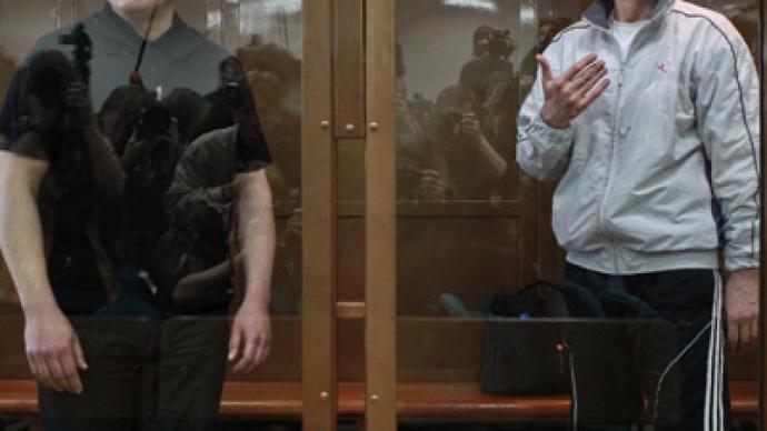 Moscow court reduces jail term for Khodorkovsky, partner