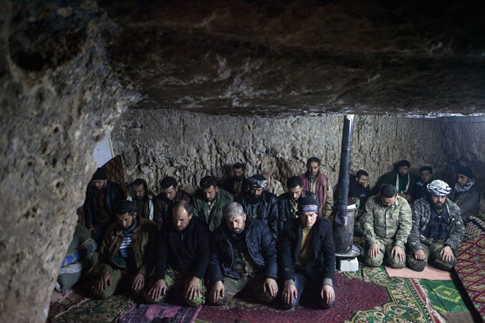 Rebels pray inside a cave in the village of Kfarruma in the flashpoint Syrian province of Idlib near the border with Turkey, on February 10, 2013. (AFP Photo/Daniel Leal-Olivas)