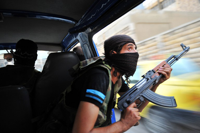 Syrian rebels hunt for snipers after attacking the municipality building in the city center of Selehattin, near Aleppo, on July 23, 2012, during fights between rebels and Syrian troops. (AFP Photo / Bulent Kilic)