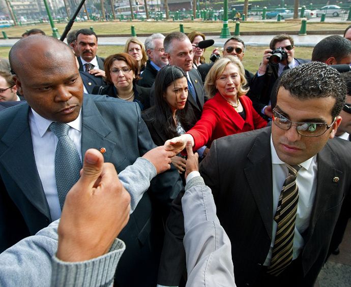 US Secretary of State Hillary Clinton (C) shakes hands with Egyptians as she takes an unannounced walk through Tahrir Square, the epicentre of the 18 days of protests that overthrew long time ally Hosni Mubarak, on March 16, 2011. (AFP Photo / Paul J. Richards)