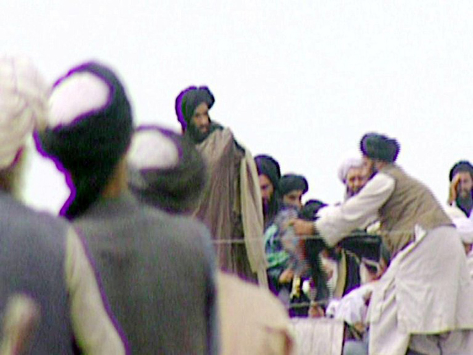 TV grabs taken secretly by BBC Newsnight shows Taliban's one-eyed spiritual leader Mullah Mohammed Omar (C) during a rally of his troops in Kandahar before their victorious assault on Kabul in 1996. (AFP Photo / BBC News)