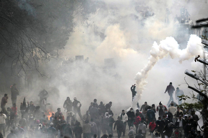 Protesters run from tear gas thrown by police forces during clashes near the Interior Ministry in Cairo, February 3, 2012. (Reuters/Mohamed Abd El-Ghany)