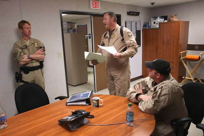 Staff from the U.S. Air and Marine discuss sequestration furloughs before launching Predator drone surveillance flights near the Mexican border on March 7, 2013 from Fort Huachuca in Sierra Vista, Arizona (John Moore / Getty Images / AFP) 
