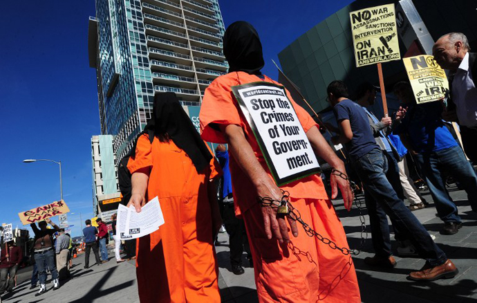 Demonstrators dressed as a Guantanamo Bay prisoners attend a "No War on Iran" protest in Los Angeles, California, on February 4, 2012. (AFP Photo / Frederic J. Brown)