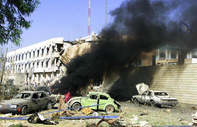An August 19, 2003 file photo shows a car burning outside the United Nations headquarters at the Canal Hotel in eastern Baghdad after a huge explosion rocked the building leaving several people dead (AFP Photo / Sabah Arar) 