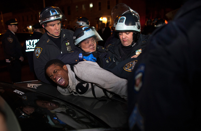 NYPD officers arrest a young man during a protest against the killing of 16-year-old Kimani "Kiki" Gray who was killed in a shooting involving the NYPD, in the Brooklyn borough of New York March 13, 2013 (Reuters / Eduardo Munoz)