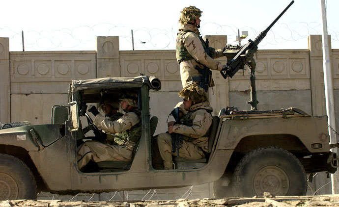 US soldiers from the 1st Battalion, 22nd Regiment of the 4th Infantry Division, ride on a military vehicle as they leave their base on a mission in Tikrit, 180 Kilometers (110 miles) north of Iraqi capital Baghdad.(AFP Photo / Jewel Samad)