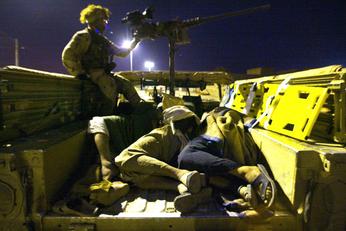 Three Iraqi detainees await inside a Humvee military vehicle during a raid in the area by US troops, on outskirts of Tikrit, 180 kms (110 miles) north of Iraq's capital Baghdad.(AFP Photo / Mauricio Lima)