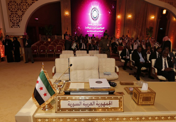 A pre-Baath Syrian flag, currently used by the Syrian opposition, is seen in front of the seat of the Syrian delegation at the opening of the Arab League summit in the Qatari capital Doha on March 26, 2013. (AFP Photo / Karim Sahib)