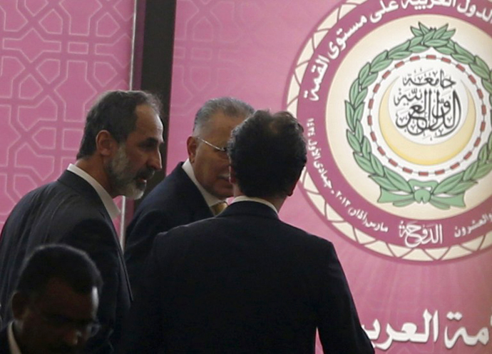Ahmed Moaz al-Khatib (L), head of the Syrian opposition delegation attends the opening of the Arab League summit in the Qatari capital, Doha, on March 26, 2013. (AFP Photo / Karim Sahib)