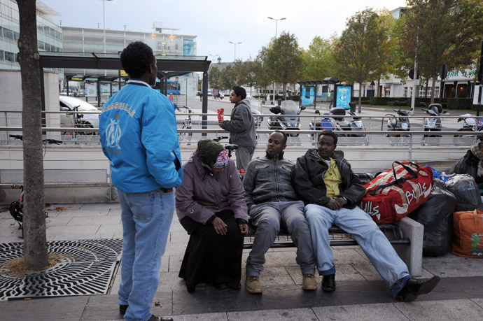 Migrants seeking asylum in France, prepare to spend a night outside the railway station in Angers, centre France (AFP Photo)