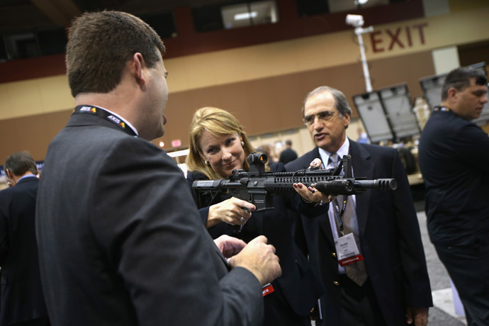 Expo attendants check out rifles at the Border Security Expo on March 12, 2013 in Phoenix, Arizona. (John Moore/Getty Images/AFP)