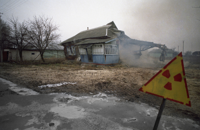 An abandoned village in the Chernobyl area is torn down because of excessive radiation. (RIA Novosti / Igor Kostin)