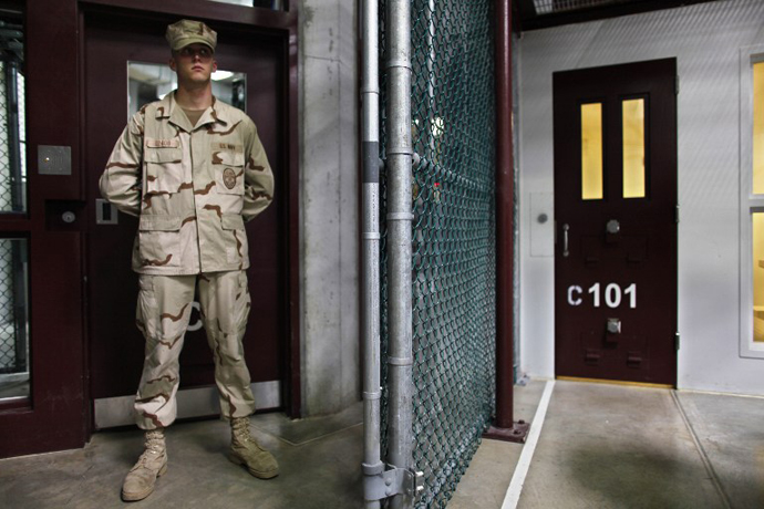 A Guantanamo guard stands inside a doorway at Camp 6 detention facility at Guantanamo Bay U.S. Naval Base, Cuba. (AFP Photo / Brennan Linsley)
