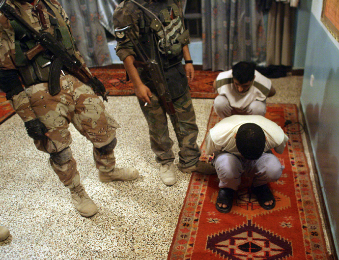 Iraqi soldiers guard suspected al Qaeda militants during a night raid in Baquba. (Reuters / Goran Tomasevic)