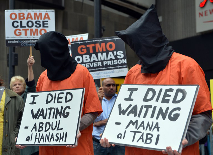 People dress in orange jumpsuits and black hoods as activists demand the closing of the US military's detention facility in Guantanamo during a protest, part of the Nationwide for Guantanamo Day of Action, April 11, 2013 in New York's Times Square. (AFP Photo / Stan Honda)