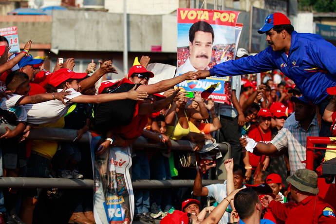 Venezuela's acting President and presidential candidate Nicolas Maduro (R) greets supporters during a campaign rally in the state of Vargas April 9, 2013 (Reuters / Carlos Garcia Rawlins)