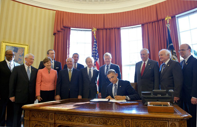 US President Barack Obama signs H.R. 6156, the Russia and Moldova Jackson-Vanik Repeal and Sergei Magnitsky Rule of Law Accountability Act, on December 14, 2012 in the Oval Office of the White House in Washington, DC. (AFP Photo / Mandel Ngan)