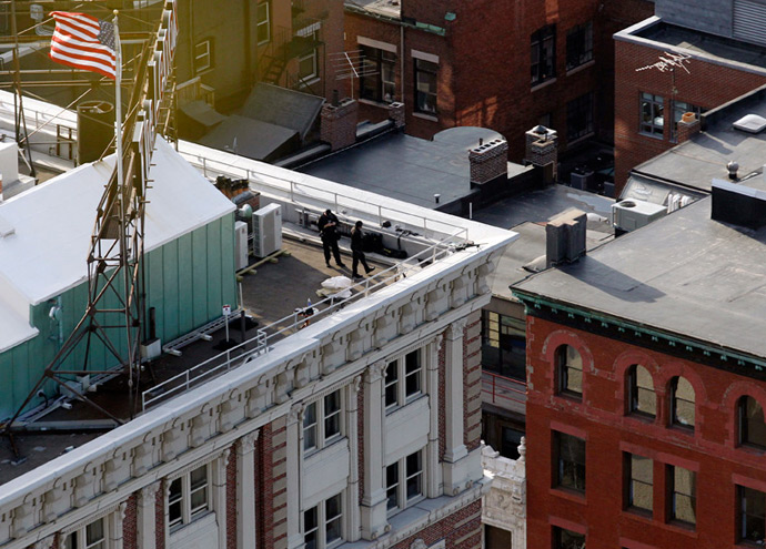 Police are seen on the roof of a building overlooking Boylston Street where explosions went off at the 117th Boston Marathon in Boston, Massachusetts April 15, 2013 (Reuters / Jessica Rinaldi)