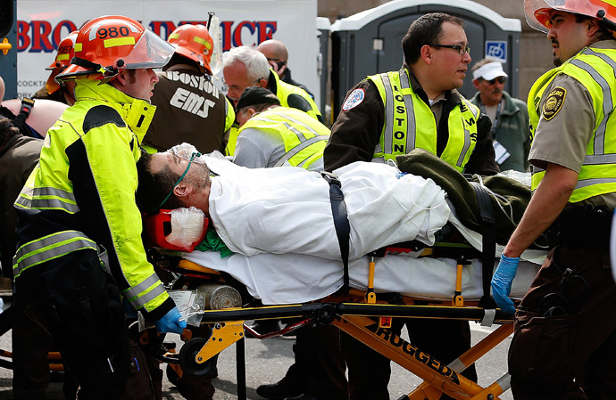 A man is loaded into an ambulance after he was injured by one of two bombs exploded during the 117th Boston Marathon near Copley Square on April 15, 2013 in Boston, Massachusetts (AFP Photo / Jim Rogash)