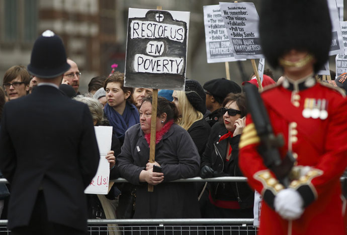 Protesters holding placards demonstrate against Thatcher in the streets during the ceremonial funeral of British former prime minister Margaret Thatcher in St Paul's Cathedral in central London on April 17, 2013.(AFP Photo / Justin Tallis)