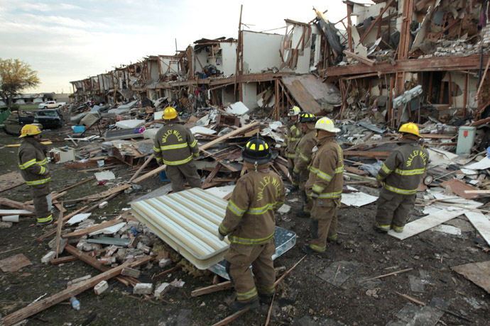 alley Mills Fire Department personnel walk among the remains of an apartment complex next to the fertilizer plant that exploded yesterday afternoon on April 18, 2013 in West, Texas. (Erich Schlegel/Getty Images/AFP)