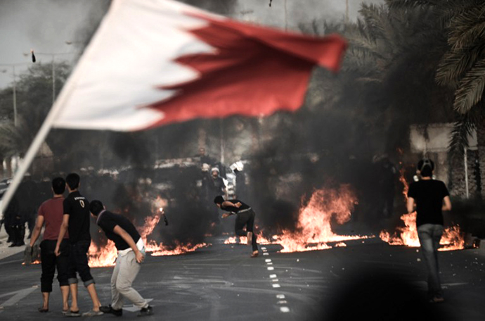 Bahraini anti-regime protestors throw petrol bombs towards riot police during clashes following the funeral of Abd Al-Ghani Al-Rayes in the village of Diraz, west of Manama on April 1, 2013. (AFP Photo / Mohammed Al-Shaikh)