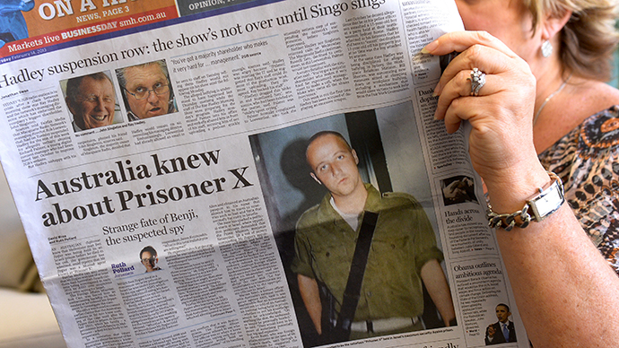 A woman poses with an Australian newspaper showing the front page story of Ben Zygier, as Israel confirms it jailed a foreigner in solitary confinement on security grounds who later committed suicide, with Australia admitting it knew one of its citizens had been detained. (AFP Photo / William West)