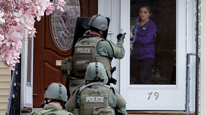 A member of the SWAT team motions to a resident to come out of the house as they conduct a house to house search for Dzhokar Tsarnaev, the one remaining suspect in the Boston Marathon bombing, in Watertown, Massachusetts April 19, 2013.(Reuters / Brian Snyder)