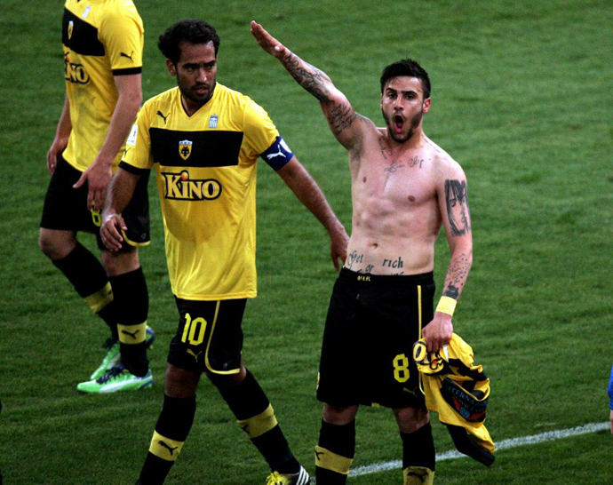 This picture taken on March 16, 2013 shows Giorgos Katidis (R) celebrating a goal with a Nazi salute during a Greek Superleague football game in Athens. Katidis on March 17, was banned for life from playing for Greece for having given a Nazi salute during a game. (AFP Photo)