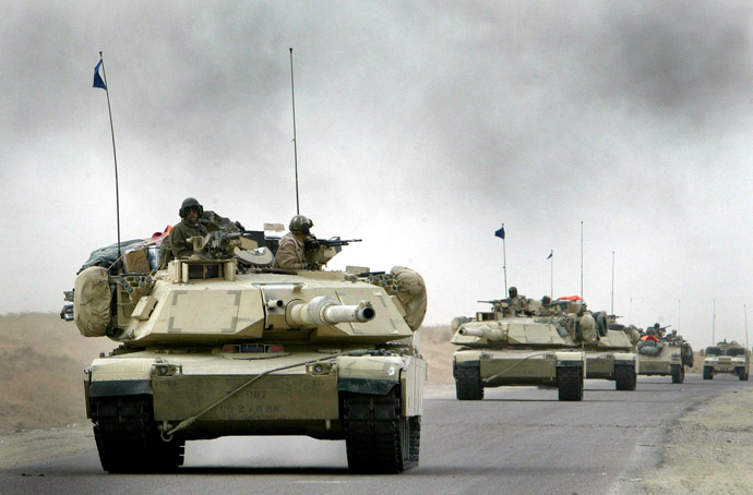 A convoy of US Army 3rd Infantry M1A1 Abrams tanks cross the Euphrates river as black smoke rises after an explosion as hundreds of armored vehicles push towards the outskirts of Baghdad on April 6, 2003. (Reuters)