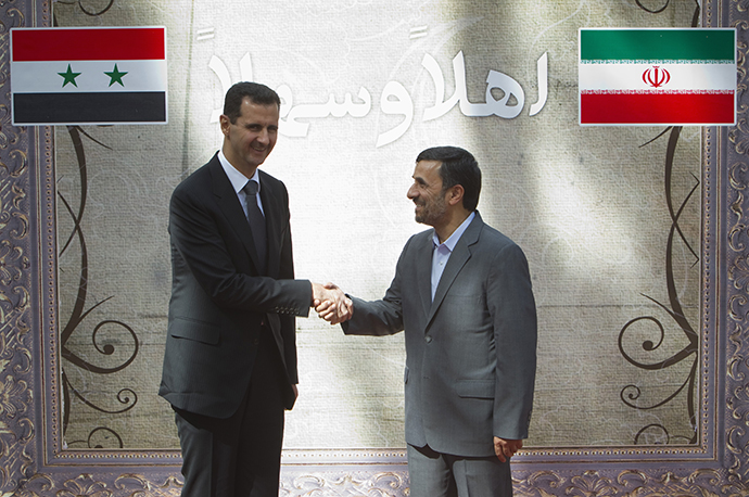 Iranian President Ahmadinejad shakes hands with his Syrian counterpart al-Assad during an official welcoming ceremony in Tehran on October 2, 2010. (Reuters / Morteza Nikoubazl)