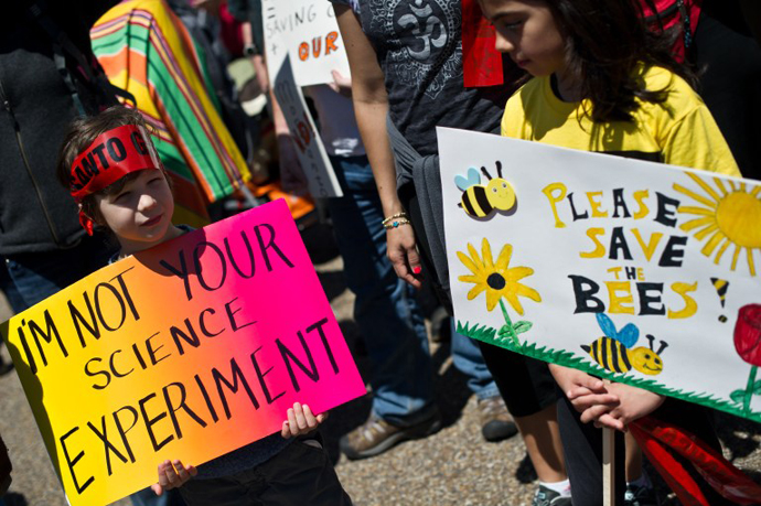 Children hold signs during a demonstration against agribusiness giant Monsanto and genetically modified organisms (GMO) in front of the White House in Washington on May 25, 2013. (AFP Photo / Nicholas Kamm)