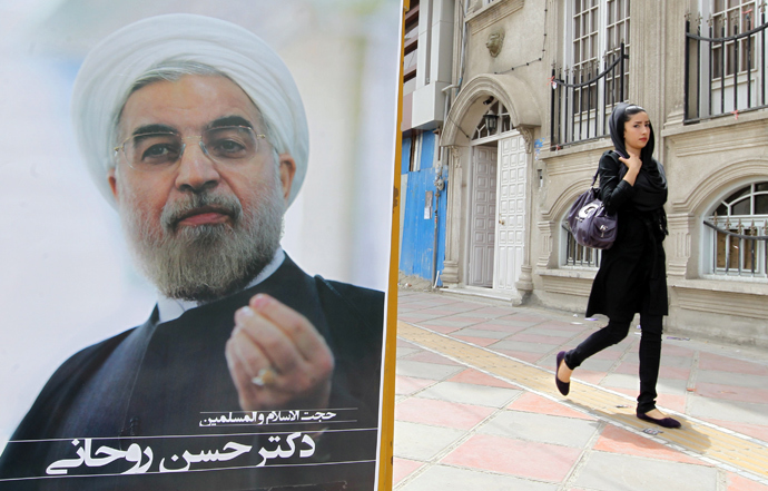 An Iranian woman walks past a campaign poster of Hassan Rowhani, moderate presidential candidate and former top nuclear negotiator, in Tehran on June 11, 2013 (AFP Photo / Atta Kenare)